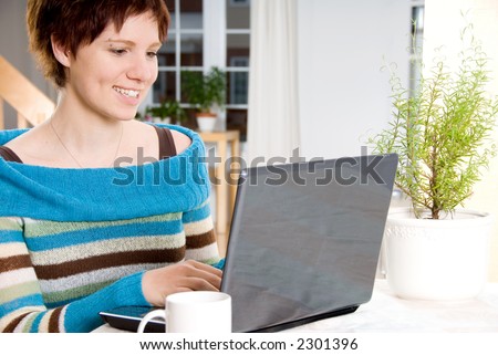 girl happy working with her laptop on the table