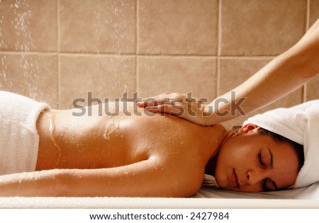 Woman getting a water massage in a day spa