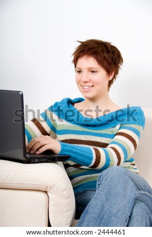 cute woman on the couch with her laptop