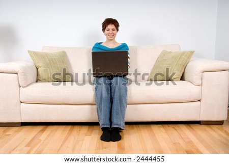woman on her laptop sitting on the sofa