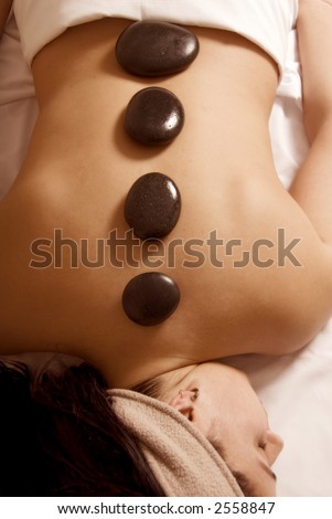 cute girl getting a stone massage in a spa