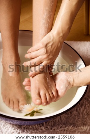 woman getting a foot massage with some cream