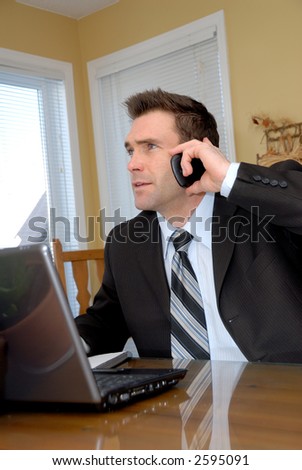 man in a suit and tie talking on the phone