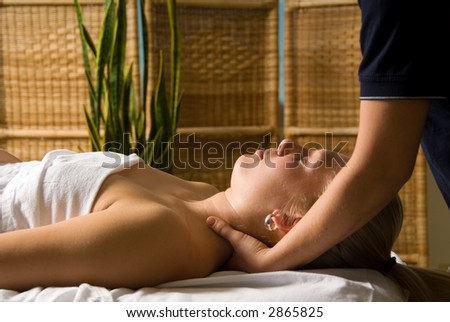 woman in a day spa getting a neck massage
