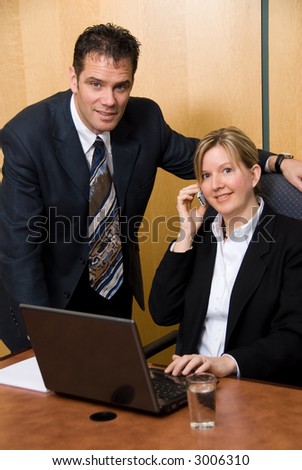 two business people in a meeting with a laptop