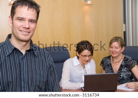 3 business colleagues in a meeting room