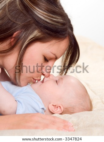 mom kissing her lovely baby boy portrait
