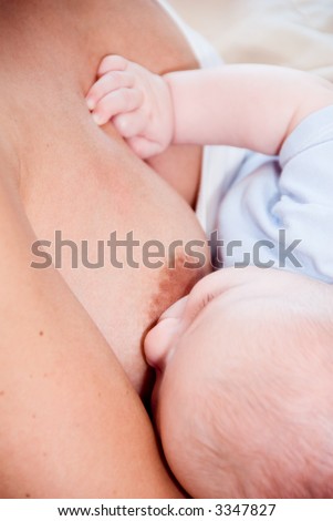 mom breast feeding her hungry baby boy
