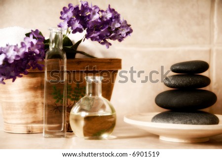 day spa products with stones, oil container, flowers