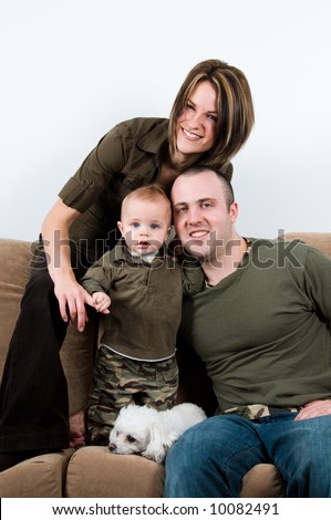 mom and dad on a sofa with their baby boy