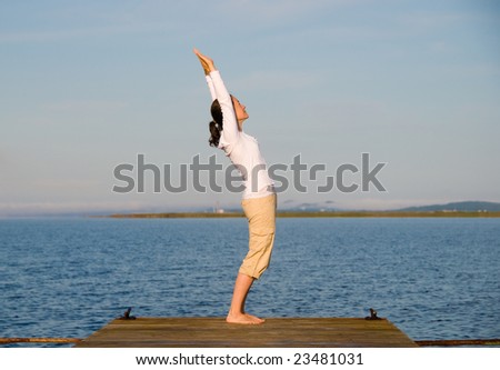 Yoga Woman on a dock by the ocean