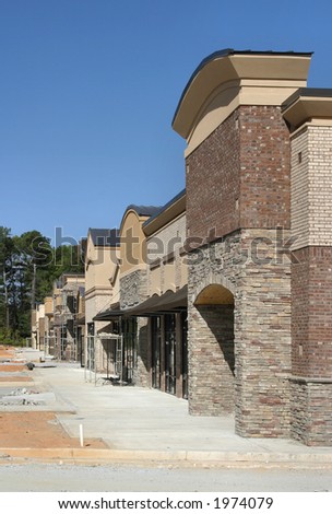 A strip mall under construction, designed to appear like a small town main street.