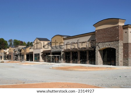 A shopping center under construction, made to appear like a small town street.