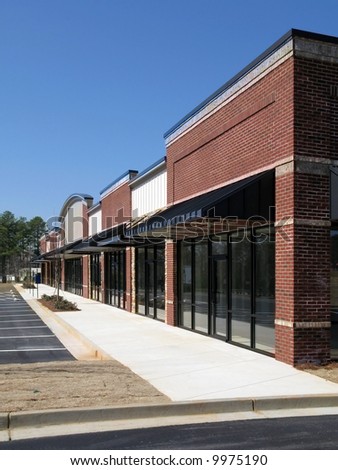 A small suburban shopping center in the final stages of construction.