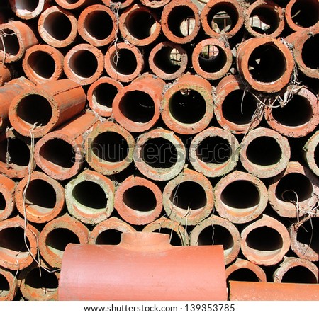 A pile of clay drainage pipes