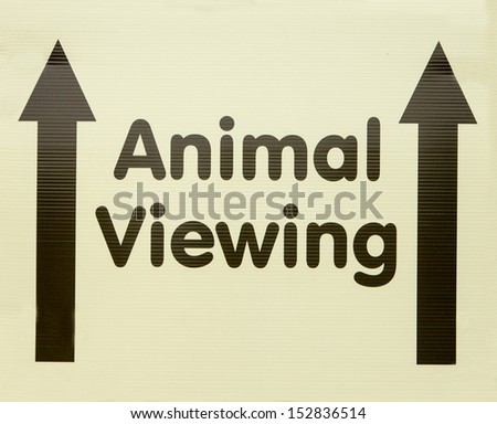 A sign directing people straight ahead to an animal viewing area
