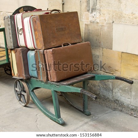 A station trolley with a load of old fashioned suitcases