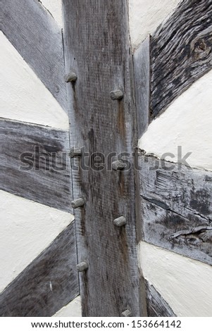 Wooden beams in a Tudor building showing the wooden pegs used instead of nails