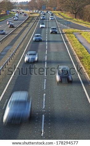 Cars rushing along a road to get home after a days work