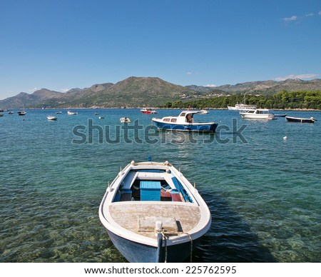 A coastal view of boats in a sunny bay