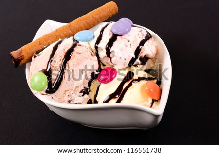 Ice cream bowl on the black background. Selective focus on the front side