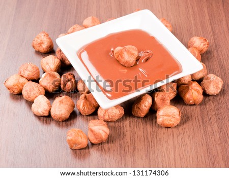 Sweet nuts cream on wooden background. Selective focus on the nut cream