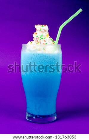 Icy blue milk shake on purple background