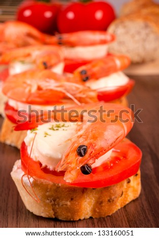 Bruschetta sandwich with shrimp. Selective focus on the front shrimp
