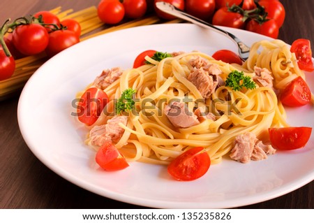 Spaghetti with the fresh tuna fish. Selective focus on the content of plate