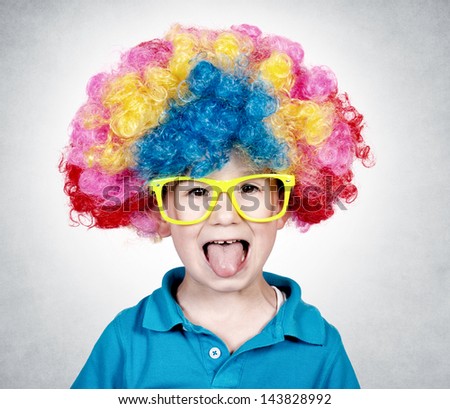 Little boy wearing clown wig and mocks