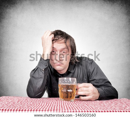 Drunk man holding the pint of beer