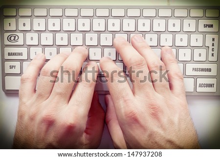 Male hands on the keyboard from above
