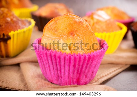 Selective focus on the homemade muffin in pink cup