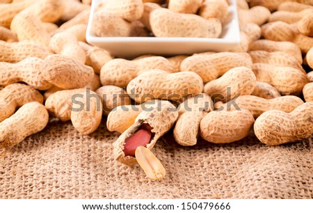 Selective focus on the front raw peanut in shell