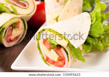 Fresh wrap snadwich with turkey meat and fresh vegetables