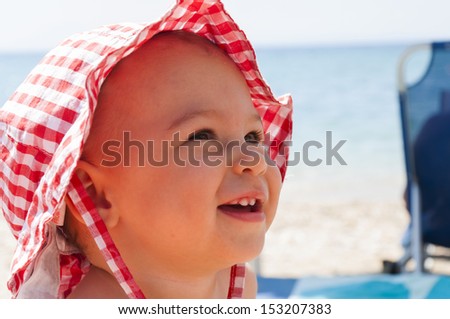 Little baby with smile at the beach
