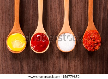 Food ingredients in the wooden ladles from above
