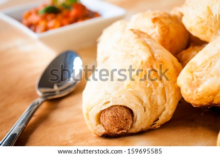 Mini pastry rolls with sausage. Selective focus on the front sausage roll