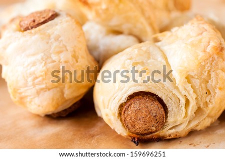 Fried pork sausages in the pastry. Selective focus on the front sausage roll