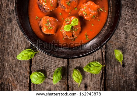 Homemade meat balls and tomato sauce in the old pan from above