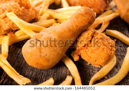 French fries and deep fried chicken legs on the table