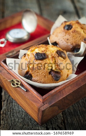 Homemade sponge cake with dried cranberries in the wooden box.Selective focus on the sponge cake