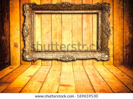 Old wooden background with vintage empty frame
