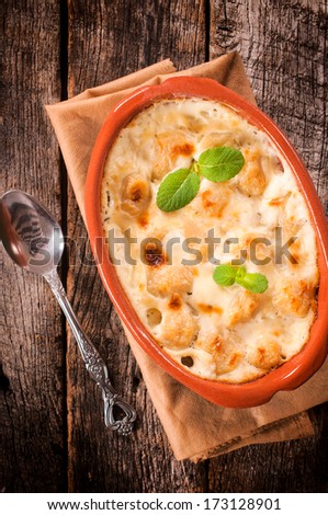 Traditional homemade gnocchi in the stew with melting cheese
