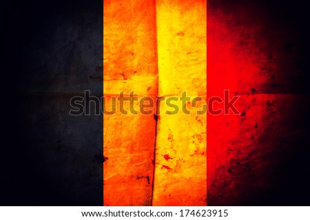 Old creased paper with Belgian flag as the background