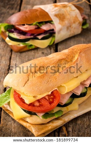 Selective focus on the front tasty sandwich on wooden table