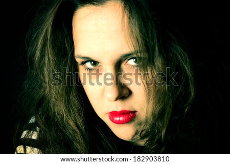 Portrait of sad female with green eyes and red lips