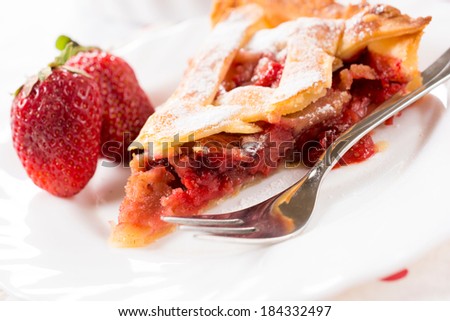 Piece of strawberry pie in the plate.Selective focus on the slice of pie