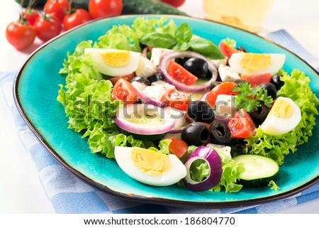 Fresh spring salad with vegetables and cheese.Selective focus on the front part of salad