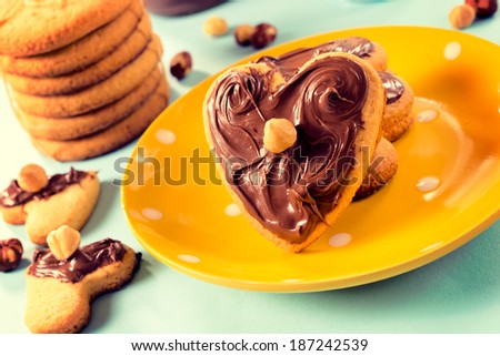 Sweet nougat cream on the heart shape cookies.Selective focus on the big right cookie
